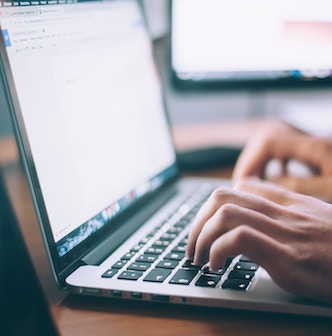 A person typing on a laptop.