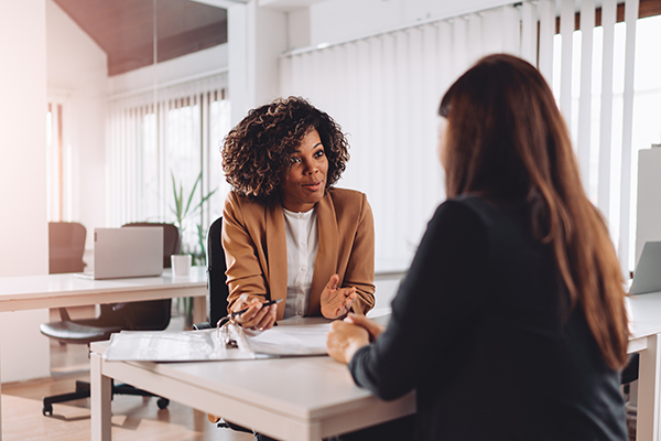 Young woman receiving assistance from business adviser
