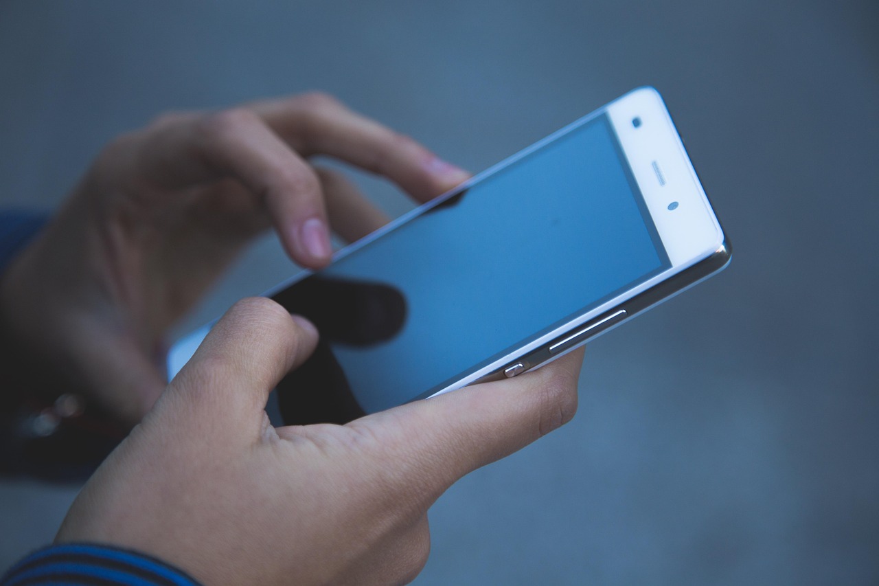 hands on a smartphone being used