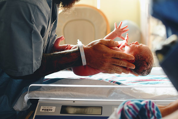 newborn baby being cared for
