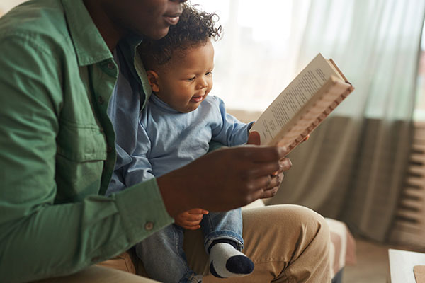 father reading to his infant