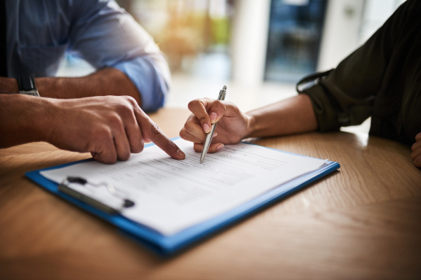 Two people reviewing a paper contract