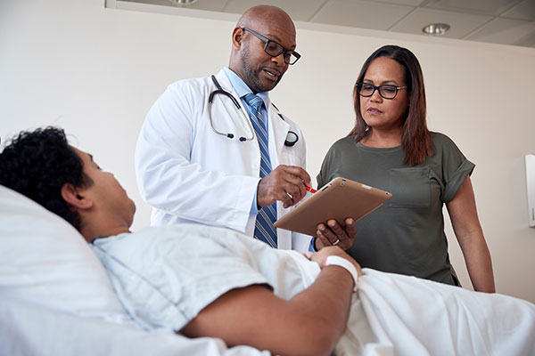 doctor reviewing chart with patient